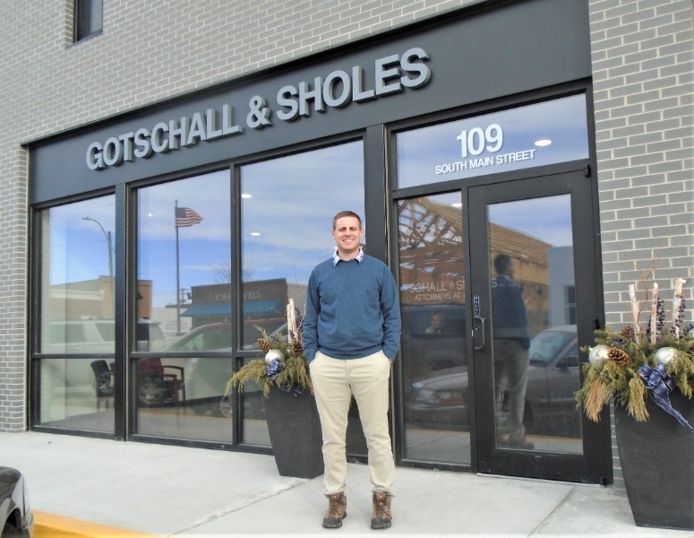 Attorney Michael Sholes stands outside his new office building on Main Street in downtown Atkinson.